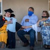 Jacqueline Hernandez Rico, 33, gets a hug from her son Ivan Santiago Hernandez, 6, while watching the Raza Grad online with her parents, Salvador and Delia Rico, at their home in Perris on June 13, 2020. Hernandez, a sociology major, and other students celebrated their graduations remotely while the campus remained closed due to COVID-19. (UCR/Stan Lim)